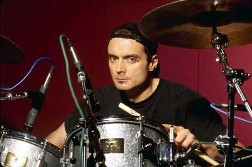 Virgil Donati behind a drum kit during a studio portrait.